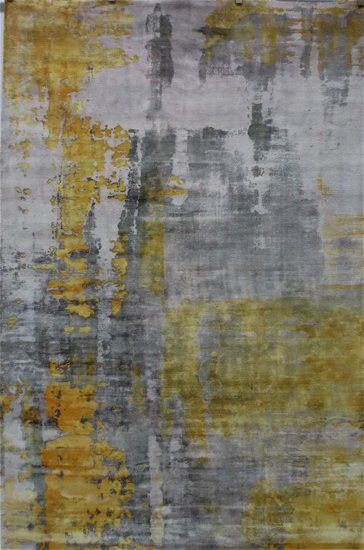 Woven Bliss – Golden Horizon rug features an abstract design with a blend of grey and yellow tones, creating a textured look. The colours merge and overlap, giving it a modern and artistic feel.