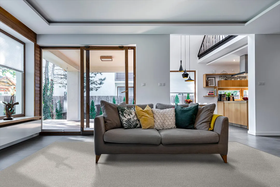 Woven Bliss – off white custom size area rug in living room with brown couch on it