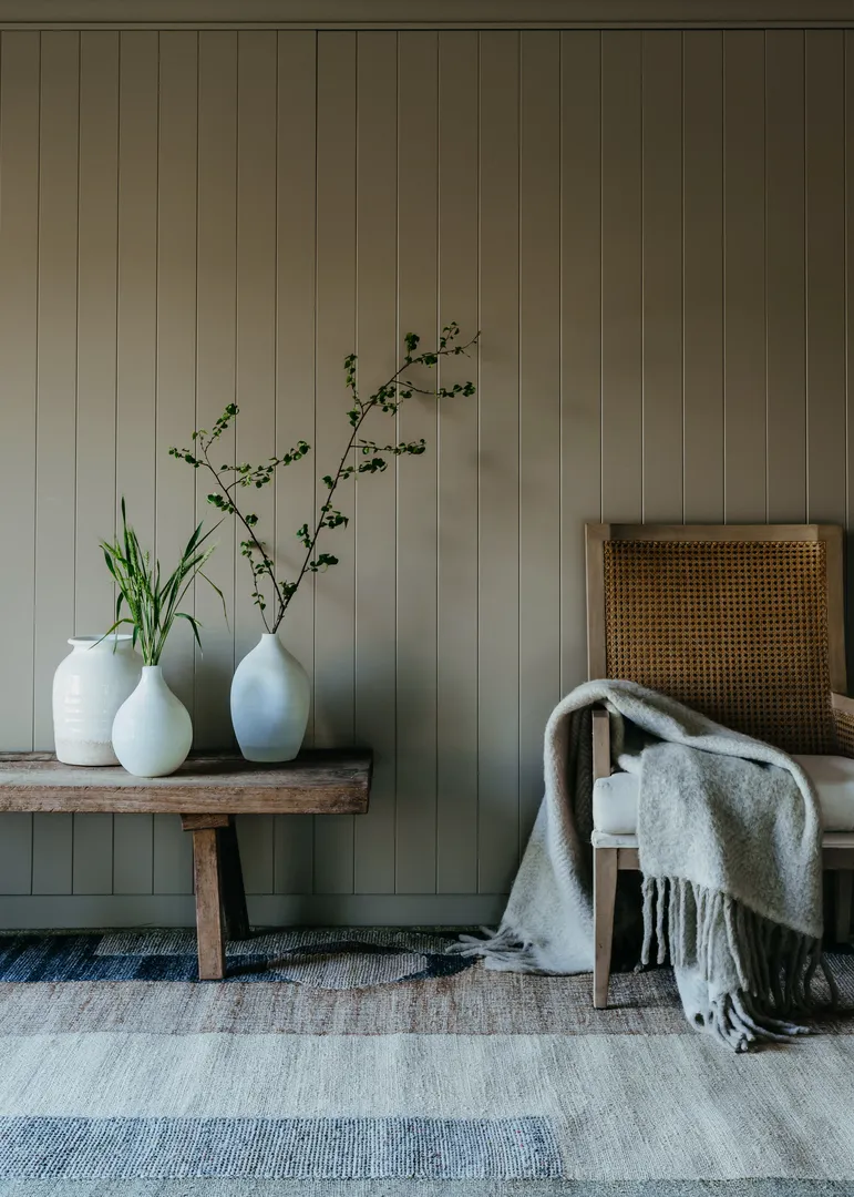 Woven Bliss – front view of abstract multi colour rug with wooden chair and table