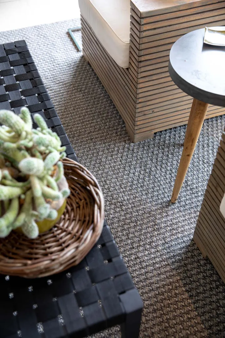 Woven Bliss – grey tugela rug on patio with furniture on it