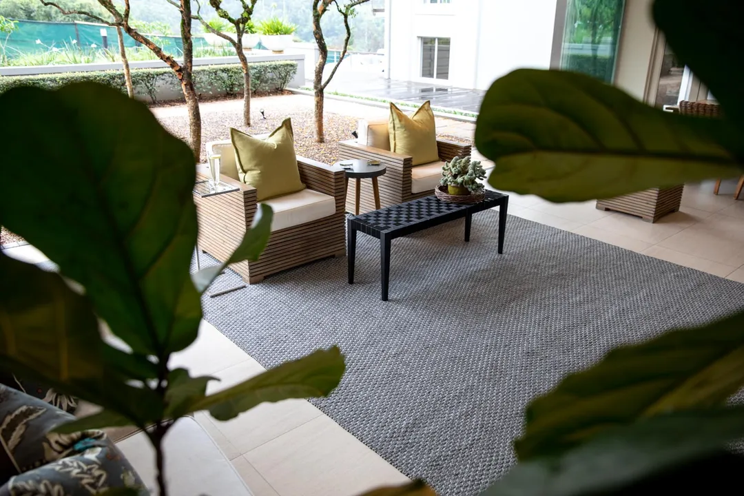 Woven Bliss – grey tugela rug on patio with furniture