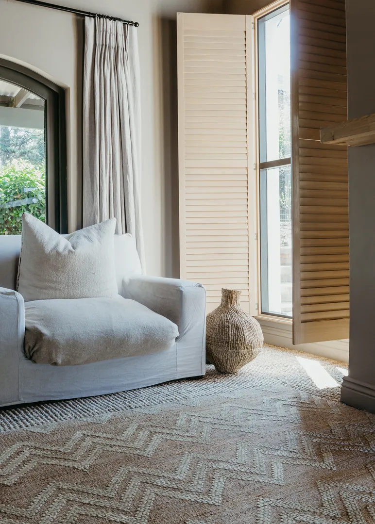 Woven Bliss – a white couch in a room with zag rug