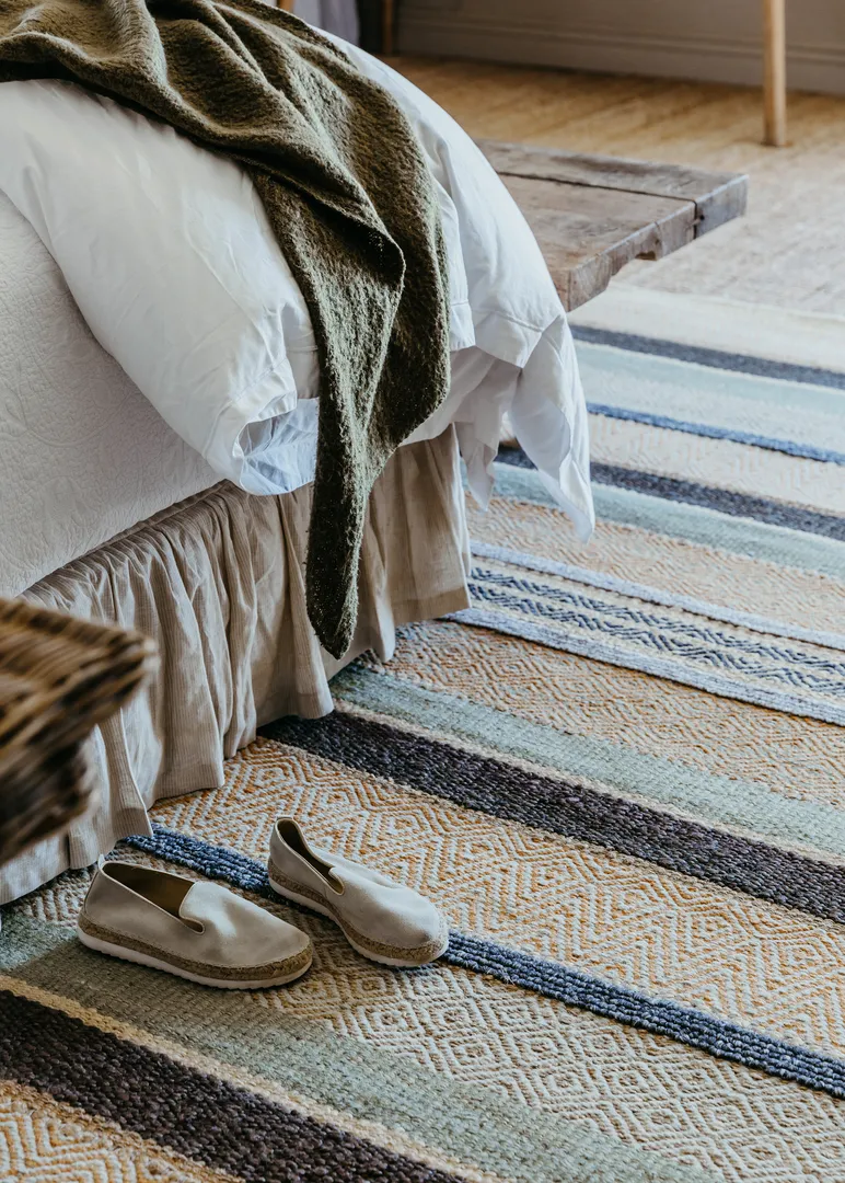 Woven Bliss – a pair of shoes on a striped Desert rug