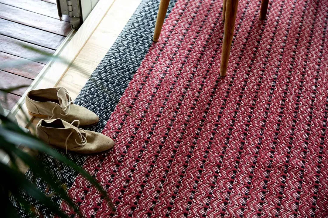 Woven Bliss – a pair of shoes on a dune wine rug