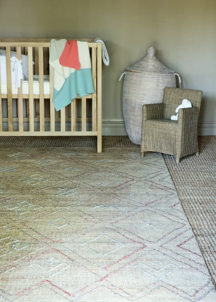 a baby crib in a room on a kimberley jute rugs