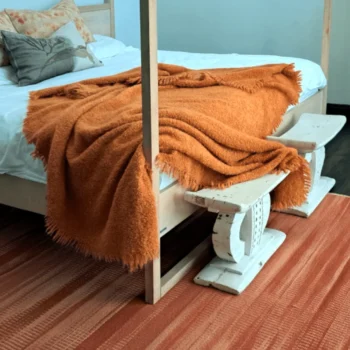 orange throw on bed