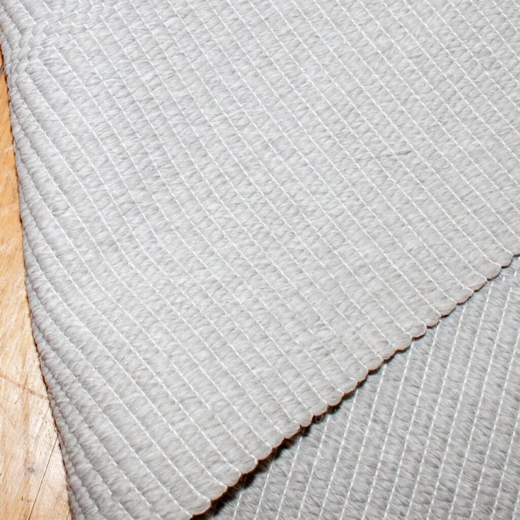 Woven Bliss – Cloud Veil Outdoor Rug folded over