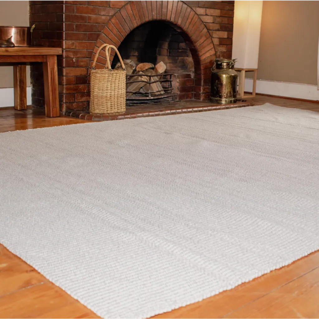 Woven Bliss – Cloud Veil Outdoor Rug in front of fire place