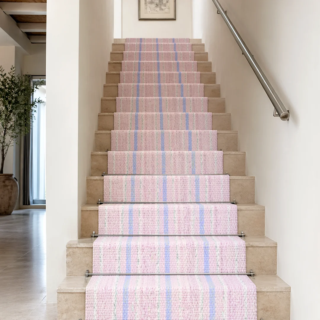 Woven Bliss – Blush pink Cavendish Pinstripe stair runner installed on cream staircase with stainless steel stair rods